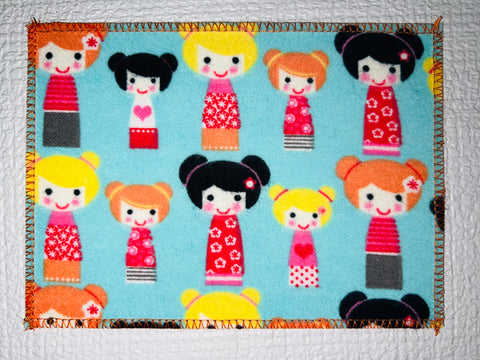 Japanese Kokeshi Dolls on Teal